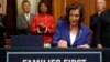 House Speaker Nancy Pelosi of Calif. accompanied by other legislators, signs the Coronavirus Aid, Relief, and Economic Security (CARES) Act. after it passed in the House on Capitol Hill, March 27, 2020, in Washington. 