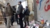 Free Syrian Army fighters stand by their weapons in a street in Homs March 9, 2013.