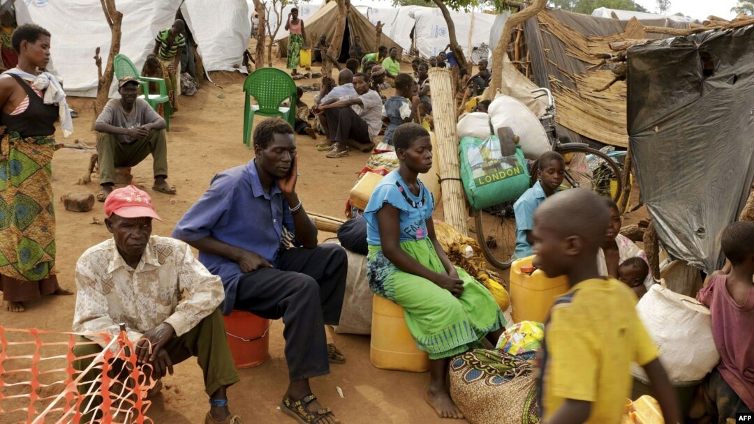 FILE - Newly arrived Mozambican refugees wait for registration at the Kapise refugee camp in the Mwanza district on the Malawian Mozambican border, Jan. 7, 2015, in Malawi.