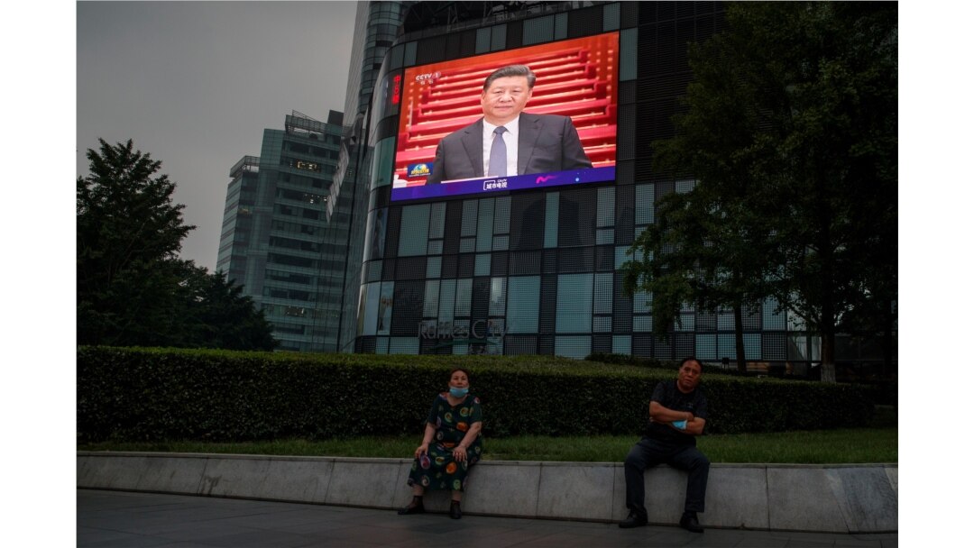 FILE - A screen at a department store shows Chinese President Xi Jinping during the opening session of the Chinese People's Political Consultative Conference at the Great Hall of the People in Beijing, China, May 21, 2020.