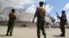 Armed police guard the Salvation Army Church after it was set on fire by rioting youths, following Friday Muslim prayers in Mombasa, Kenya, Oct. 4, 2013.