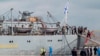 Russian sailors training on Mistral-class amphibious assault ships walk near the Russian navy frigate Smolny at Saint-Nazaire shipyard in western France June 30, 2014.