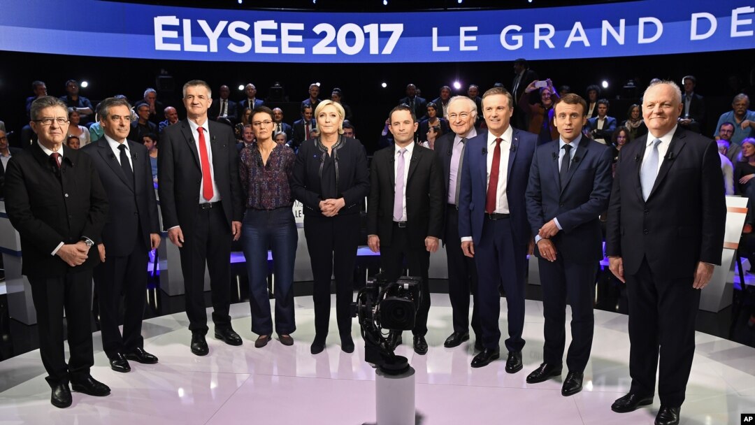 FILE - Candidates in France's presidential race pose for a group photo before a television debate at French private TV channels BFM TV and CNews, in La Plaine-Saint-Denis, outside Paris, April 4, 2017. 