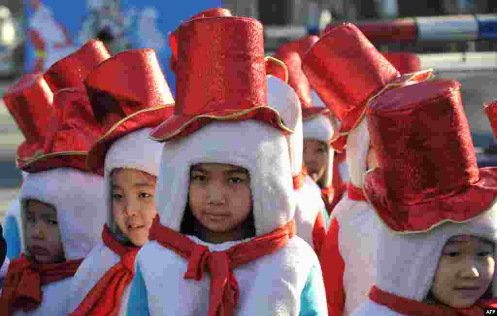 Children dressed as snowmen take part in a New Year's parade in the Kyrgyz capital Bishkek.