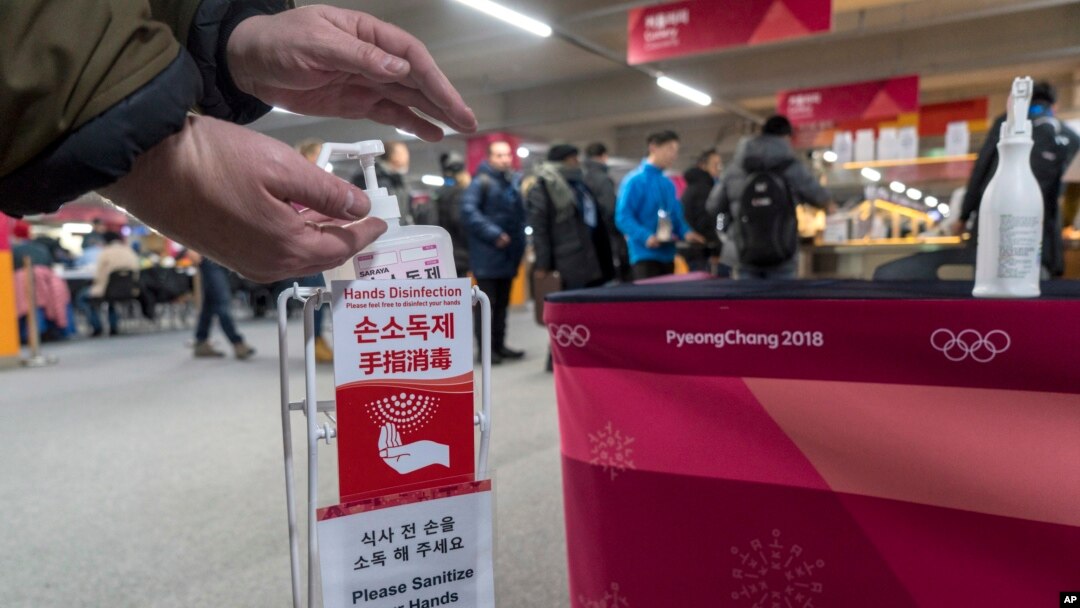 A man sanitizes his hands at the entrance to the media cafeteria, Feb. 7, 2018 in Gangneung, South Korea. There are concerns over the possible spreading of the norovirus, a contagious virus that causes stomach pain, nausea and diarrhea.