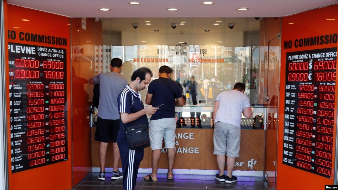 People change money at a currency exchange office in Istanbul, Turkey, Aug. 13, 2018. 
