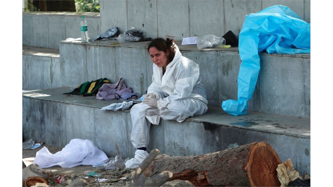 A relative of a person who died of COVID-19 mourns at a crematorium in Jammu, India, April 30, 2021.