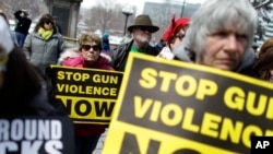 FILE - In this April 18, 2013 file photo, community gun safety advocates and members of the public hold a rally and vigil to honor victims of gun violence in Denver. 
