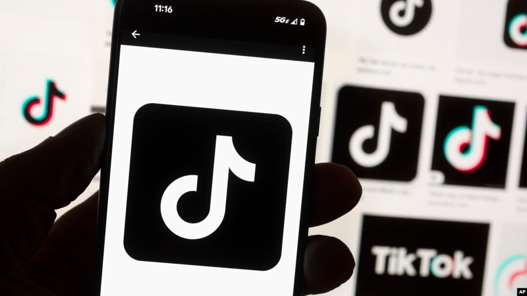 The TikTok logo is seen on a cellphone on Oct. 14, 2022, in Boston. A U.S. Commerce Department official describes TikTok as a threat.
