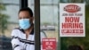FILE - A "Now Hiring" sign is seen as a customer leaves a restaurant in Mayfield Heights, Ohio, June 4, 2021. Hiring in the U.S. has picked up with many companies struggling to find enough workers to keep up with the economy's swift recovery.
