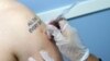 Jacob Bakkila of New York receives an Influenza Virus Injection at a Walgreens pharmacy in New York, January 10, 2013.