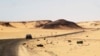 FILE - A car driving along the bandit-plagued road between Sebha and Ubari in southwestern Libya, Dec. 24, 2013. 