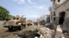 African Union Mission in Somalia (AMISOM) forces secure scene of suicide bombing outside the United Nations compound, Mogadishu, June 19, 2013.