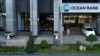  A woman walks out of a branch of Ocean Bank located in the PetroVietnam building in Hanoi, Vietnam, Sept. 1, 2017. 