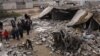 People inspect scene of car bombing in the predominantly ethnic Shabak village of al-Mouafaqiyah, near Mosul, Iraq, Dec. 17, 2012.