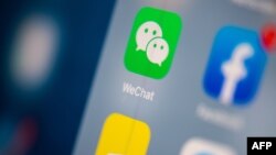 FILE - The logo of the Chinese instant messaging application WeChat is seen on the screen of a tablet in Paris.