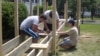 Yachad's teen volunteers build a wheelchair ramp at the New Carrollton, Maryland, home of Herson Portillo, 21, who has had cerebral palsy since birth. (Julie Taboh/VOA) 