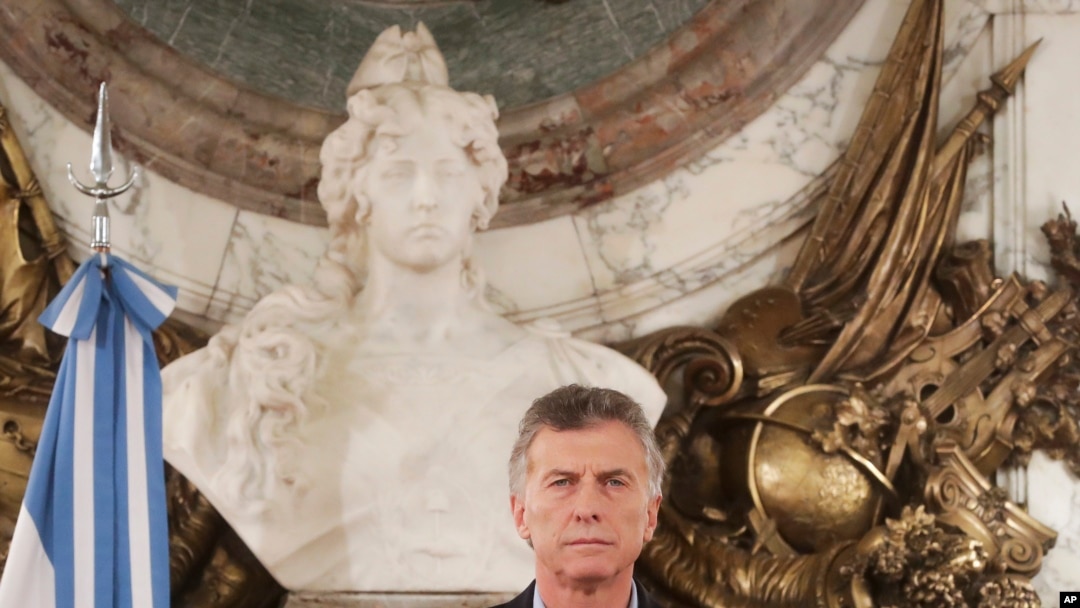 FILE - In this handout picture provided by Argentina's presidency, President Mauricio Macri pauses during a message to the nation at Government House in Buenos Aires, May 9, 2019.