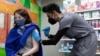 FILE - Julia Gadsby, 18, who has Lupus, receives the Pfizer-BioNTech vaccine against the coronavirus disease (COVID-19) at Skippack Pharmacy in Schwenksville, Pennsylvania, U.S., March 3, 2021. 