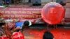 Indigenous people, including Muslims from the besiege city of Marawi, throw red paint at the mock seal of President Rodrigo Duterte to protest the continued siege and the martial law imposed by Duterte on the Mindanao region, Aug. 31, 2017, in Manila, Philippines.