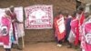 A local trachoma monitor teaches a group of Kenyan villagers how to prevent the eye disease and also how and where to get treatment.