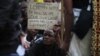 A mine worker holds up a sign during a march at Lonmin's Marikana mine in South Africa's North West Province, September 5, 2012. 
