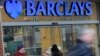 Customers wait outside a retail branch of Barclays Bank for the bank to open in London, Feb. 12, 2013.