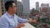Malcolm Leung, Deputy Director of the Chinatown Community Development Center, points out Chinatown and the high-rise buildings that surround it, San Francisco, California, April 8, 2016. (M. O'Sullivan/VOA)