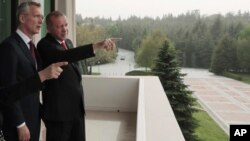 Turkey's President Recep Tayyip Erdogan, right, points toward the city center as he speaks with NATO Secretary General Jens Stoltenberg during a meeting of NATO's Mediterranean Dialogue, in Ankara, Turkey, Monday, May 6, 2019. 