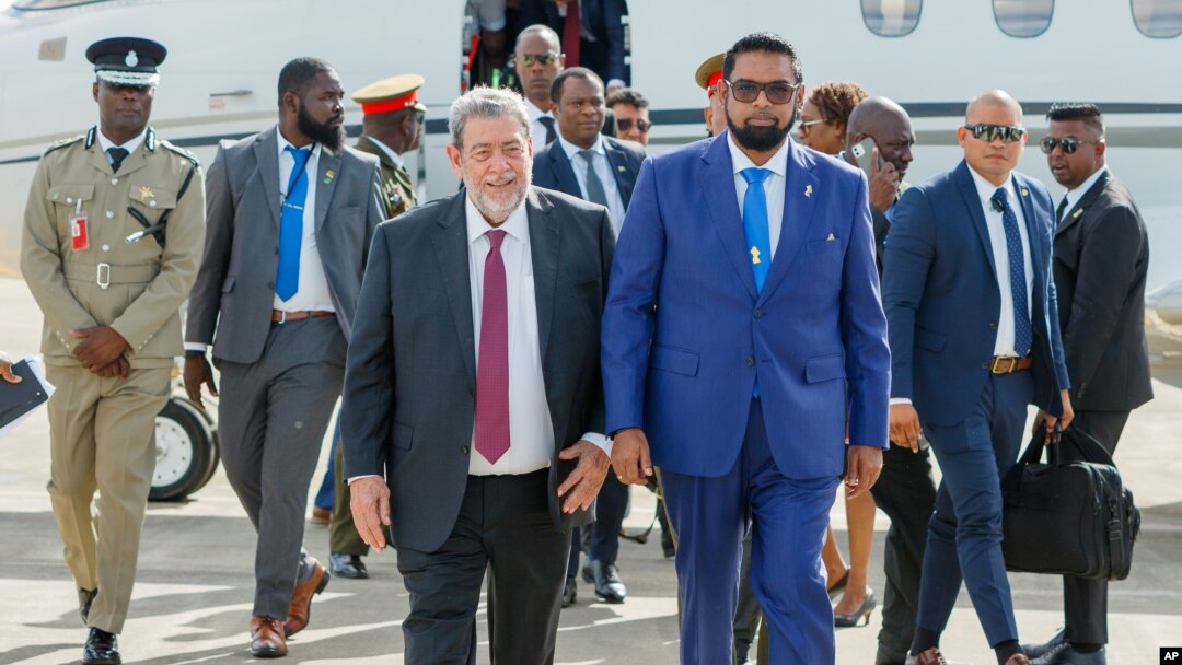 Guyanese President Irfaan Ali, right, walks with St. Vincent and the Grenadines Prime Minister Ralph Gonsalves as Ali arrives at the Argyle International Airport in Argyle, St. Vincent, on Dec. 14, 2023.