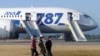 Passengers walk away from ANA's Boeing 787 Dreamliner plane after it made an emergency landing at Takamatsu airport, western Japan, Jan. 16, 2013.