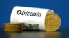 A Bitcoin paper wallet with QR codes and a coin are seen at La Maison du Bitcoin in Paris, May 27, 2015.