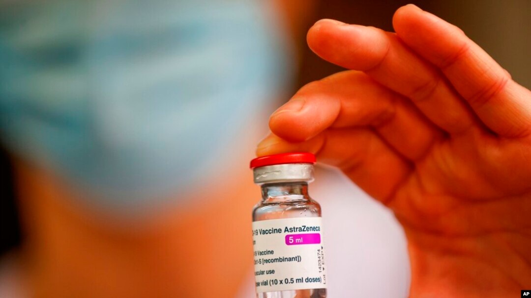 FILE - A member of the medical staff holds a vial of the AstraZeneca-Oxford COVID-19 vaccine at the South Ile-de-France Hospital Group in Melun, in the outskirts of Paris, Feb. 8, 2021. 