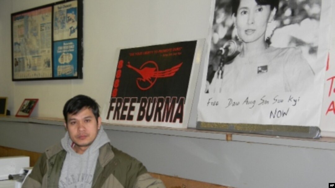Zah Win in his Buffalo, New York, laundromat where the walls are covered with posters denouncing Burma’s military junta.