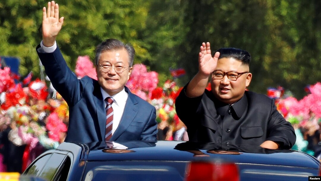 South Korean President Moon Jae-in and North Korean leader Kim Jong Un wave during a car parade in Pyongyang, North Korea, Sept. 18, 2018. 