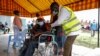 FILE - A Kenyan man receives a dose of the AstraZeneca coronavirus vaccine donated by Britain, at the Makongeni Estate in Nairobi, Kenya, Aug. 14, 2021. 