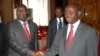 Michel Am-Nondokro Djotodia (L), leader of Central African Republic's (CAR) Seleka rebel alliance, shakes hands with CAR's President Francois Bozize (R) during peace talks with delegations representing the government and the opposition rebels in Librevill