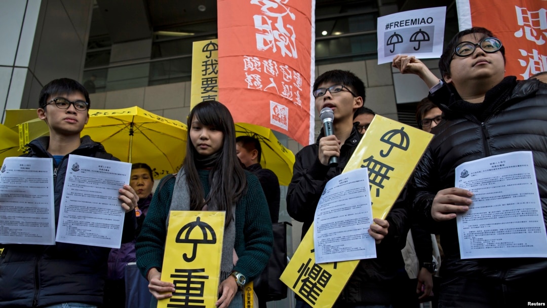 FILE -Hong Kong student leaders (L-R) Oscar Lai, Agnes Chow, Joshua Wong and Derek Lam speak as they arrive at the police headquarters in Hong Kong January 16, 2015.