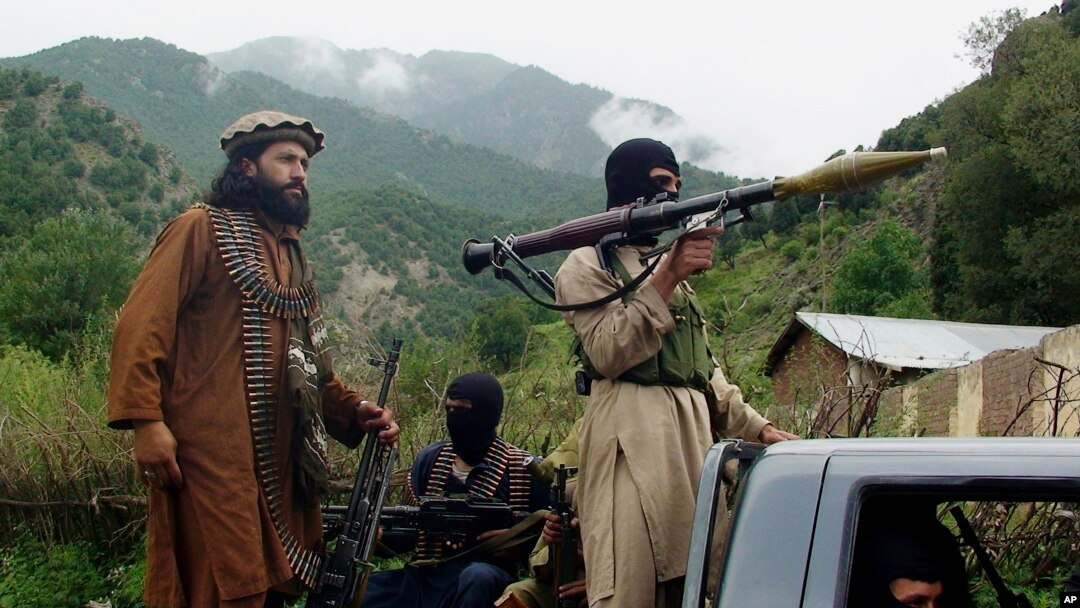 FILE - Pakistani Taliban patrol in Shawal, in the Pakistani tribal region of South Waziristan, Aug. 5, 2012.