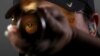 Shooting competitor Kim Rhode looks down the barrel of her shotgun as she poses for a portrait at the U.S. Olympic Committee Media Summit in Beverly Hills, Los Angeles, California, March 8, 2016.