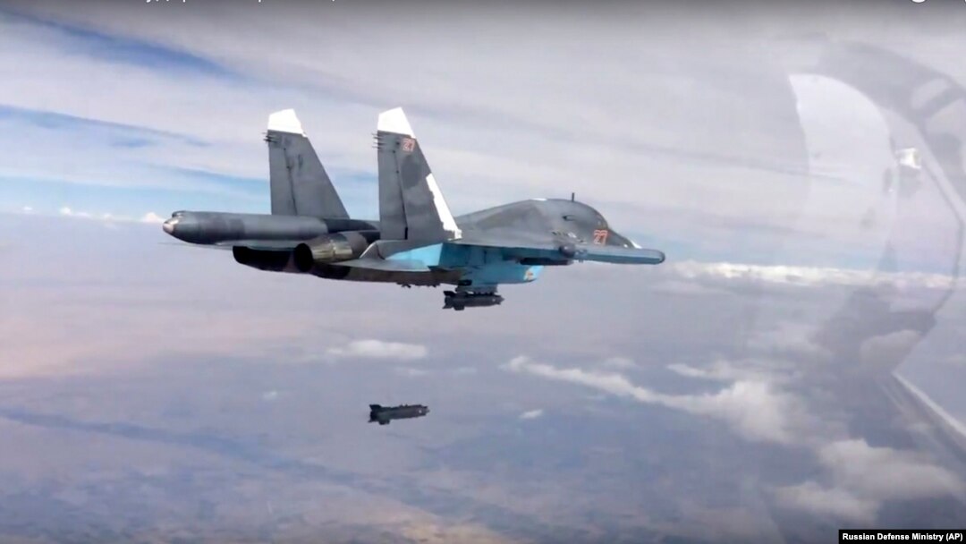FILE - A bomb is released from Russian Su-34 strike fighter in Syria, Oct. 9, 2015.