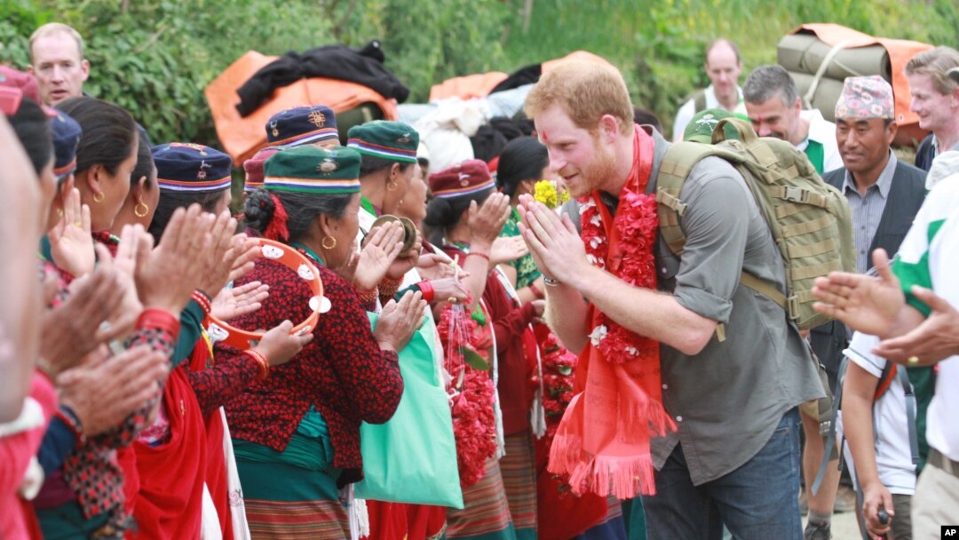 A handout photo provided by National News Agency of Nepal, shows Britain’s Prince Harry as he is welcomed by villagers upon his arrival in Lamjung, Nepal, March 21, 2016.