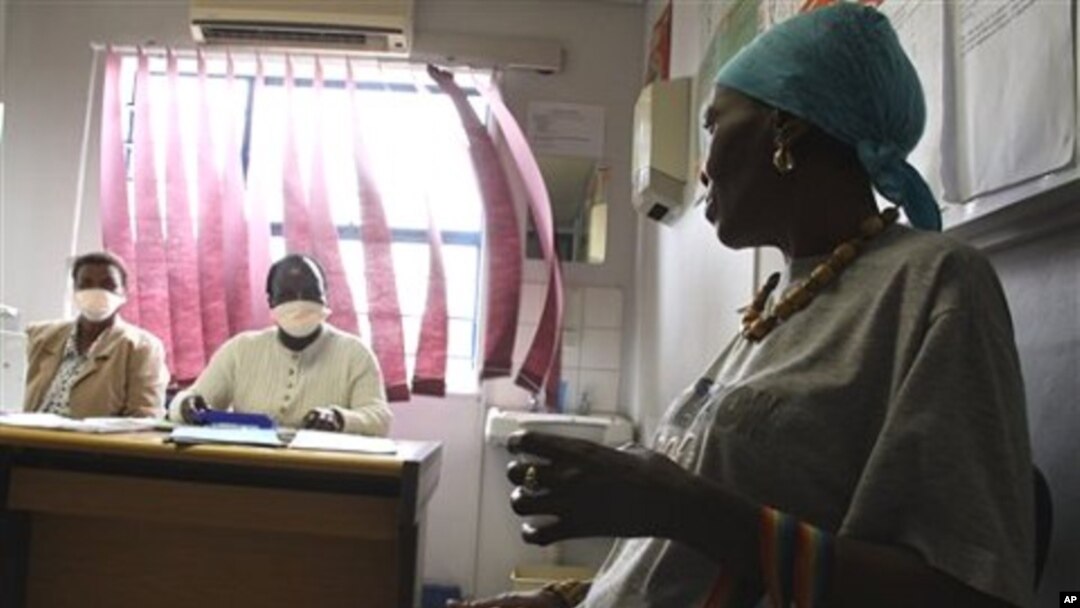 Pinky Molefe, right, gets TB medication at a clinic in Alexandra township, north of Johannesburg, 13 Oct 2010
