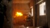 Free Syrian Army fighters take cover while firing a rocket on the front line in Izaa district in Aleppo Feb. 24, 2013. 