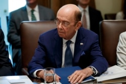 FILE - U.S. Commerce Secretary Wilbur Ross listens during a Cabinet meeting in the Cabinet Room of the White House, July 16, 2019.