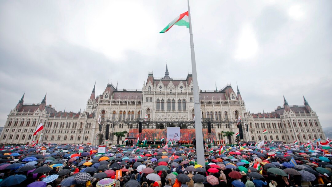 Supporters wait in the rain for Hungarian Prime Minister Viktor Orban's speech outside the Hungarian Parliament building in Budapest, Hungary, March 15, 2018, during celebrations of the Hungarian national holiday.