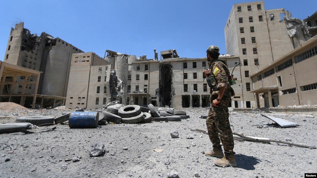 A Syria Democratic Forces (SDF) fighter walks in the silos and mills of Manbij after the SDF took control of it, in Aleppo Governorate, Syria, July 1, 2016.