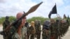 Al-Shabab fighters display weapons as they conduct military exercises in northern Mogadishu, Somalia, Oct. 21, 2010 file photo.