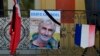 A portrait of mountain guide Frenchman Herve Gourdel hangs near a French flag outside the town hall in Saint-Martin-Vesubie, Sept. 25, 2014.