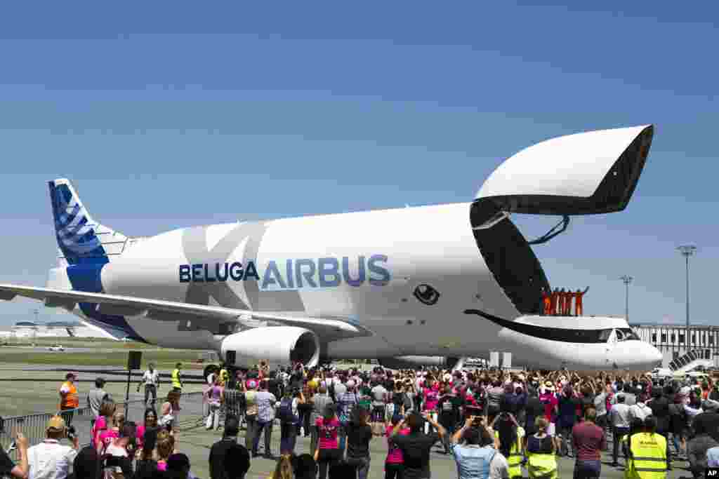 The engineers wave from the deck of the Airbus BelugaXL after successfully completing its first flight, at Toulouse-Blagnac airport, in Toulouse, France.